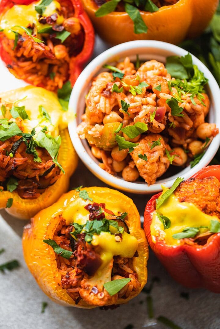 Closeup of vegan stuffed peppers with a cheesy sauce
