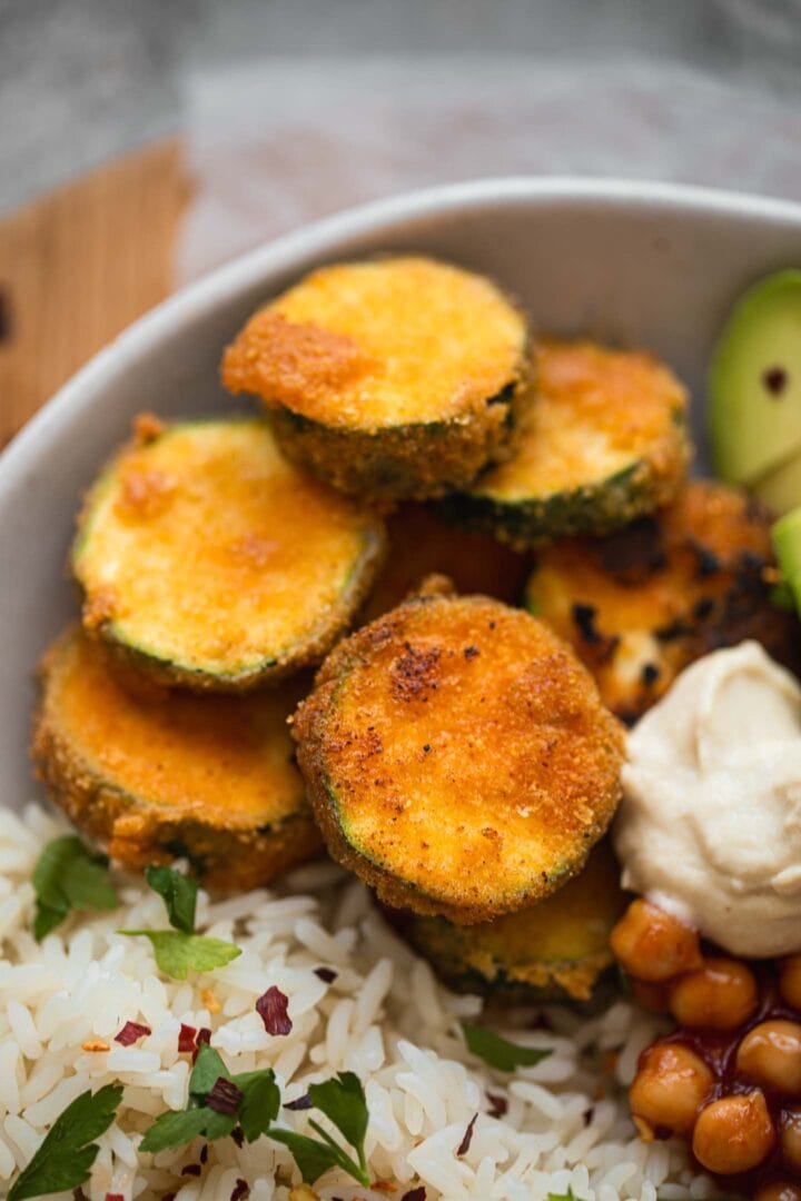 Fried zucchini chips in a bowl with rice