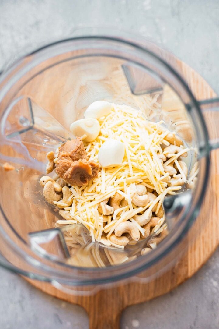 Ingredients for garlic cashew dip in a blender