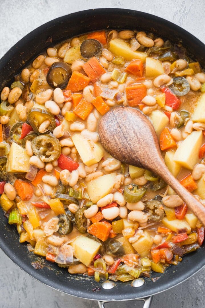 Vegetables, cannellini beans and potatoes in a frying pan
