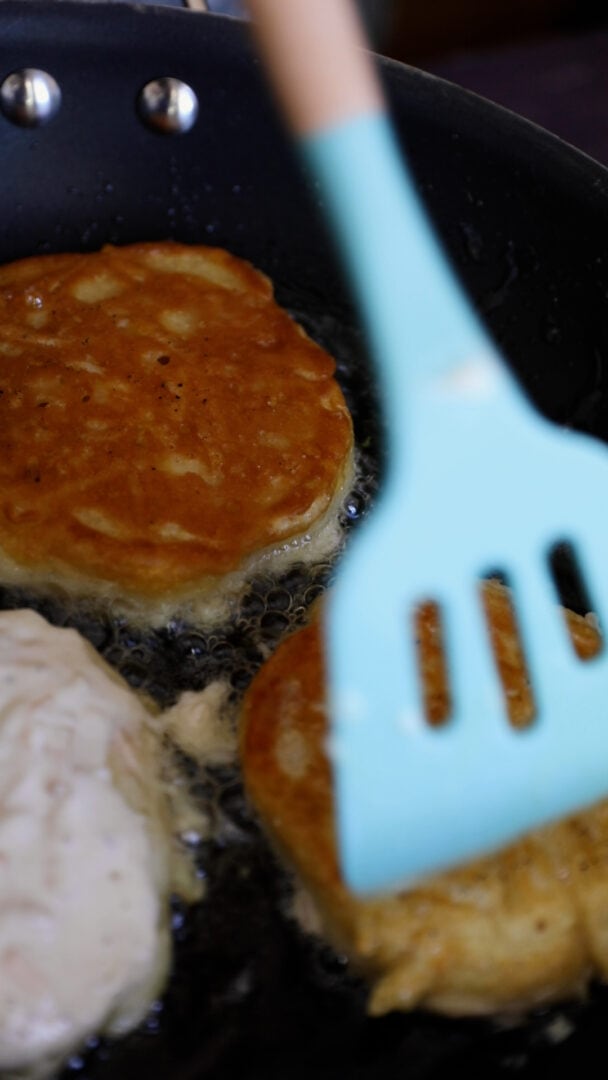 Vegan pancakes being cooked in a frying pan
