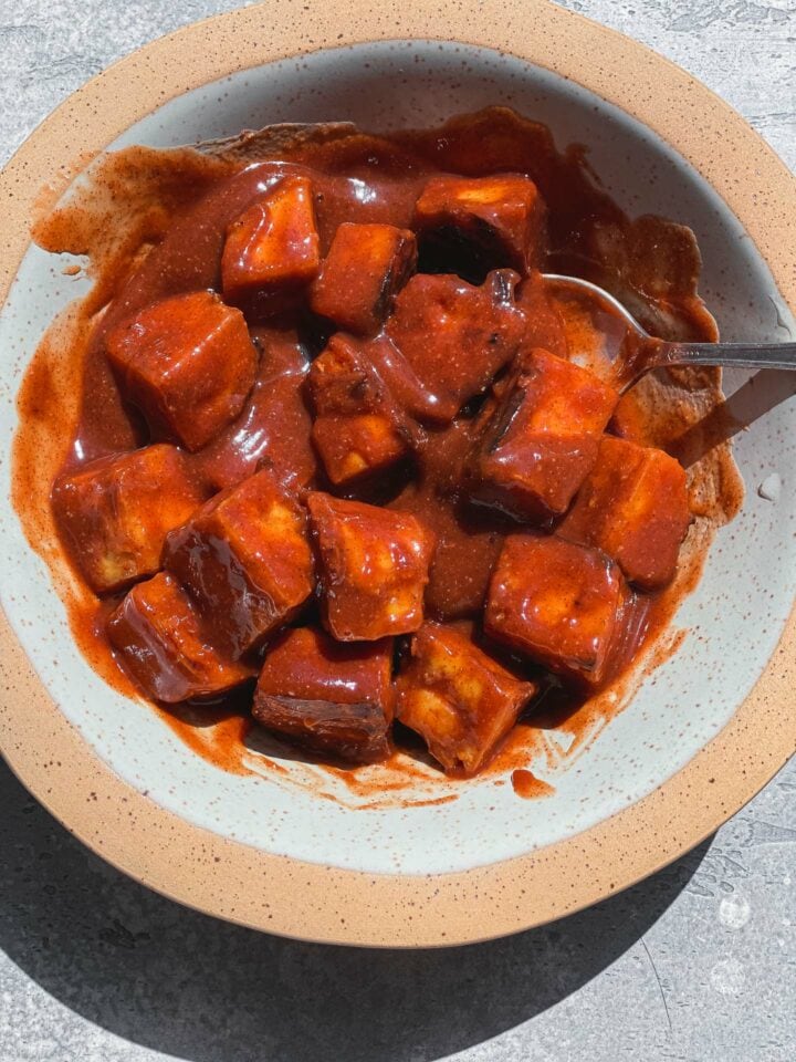 Tofu with BBQ sauce in a mixing bowl