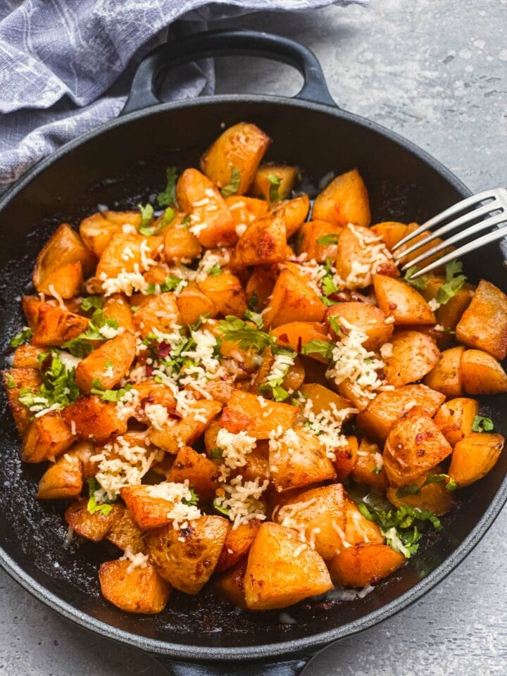 Skillet potatoes with vegan cheese and cilantro