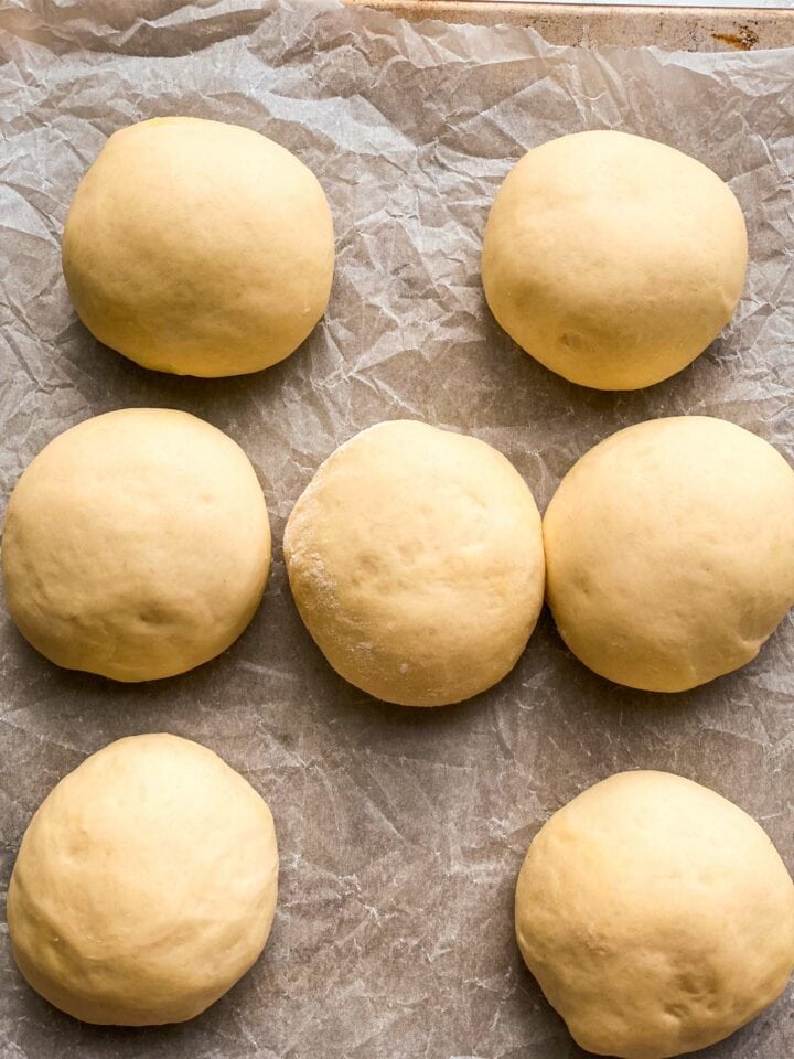 Bread rolls on a baking tray before baking