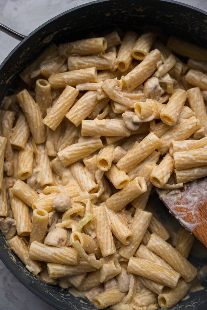 Pasta with hummus sauce in a frying pan