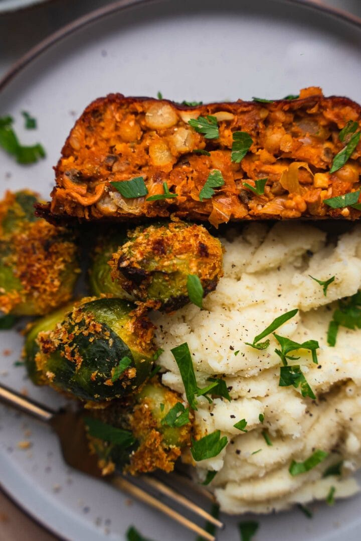 Vegan chickpea loaf with mashed potato and Brussels sprouts